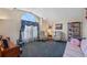 Living room with comfy armchairs, a sofa, and a large window at 960 Manchester Ave, Oviedo, FL 32765