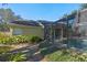 Inviting pool area with screened enclosure, lush landscaping, and stone pathway at 960 Manchester Ave, Oviedo, FL 32765