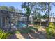 Refreshing pool with screened enclosure, surrounded by lush landscaping at 960 Manchester Ave, Oviedo, FL 32765