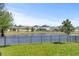Serene backyard view with a pond and black metal fence, perfect for relaxation at 10060 Pecan Hickory Way, Orlando, FL 32832
