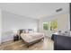 Bright bedroom with two windows, neutral colors, and hardwood floors at 10060 Pecan Hickory Way, Orlando, FL 32832