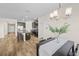 Bright dining area with a modern chandelier, with the kitchen view in the background at 10060 Pecan Hickory Way, Orlando, FL 32832