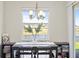 Dining area with a lake view, featuring a modern light fixture and decorative plant at 10060 Pecan Hickory Way, Orlando, FL 32832