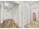Bright hallway with recessed lighting, wood-look flooring, and neutral walls with white doors at 10060 Pecan Hickory Way, Orlando, FL 32832