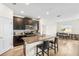 Modern kitchen with island seating, dark cabinetry, and stainless steel appliances at 10060 Pecan Hickory Way, Orlando, FL 32832