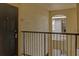 Condo hallway with dark door and metal railing at 102 Vista Verdi Cir # 320, Lake Mary, FL 32746