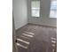 Bright bedroom with gray carpeting and large windows at 11141 Green Citron Aly, Winter Garden, FL 34787