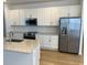 Modern kitchen with white cabinets, stainless steel appliances, and an island at 11141 Green Citron Aly, Winter Garden, FL 34787