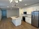 Modern kitchen with white cabinets, stainless steel appliances, and an island at 11141 Green Citron Aly, Winter Garden, FL 34787
