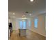 Open concept kitchen and living area with hardwood floors at 11141 Green Citron Aly, Winter Garden, FL 34787