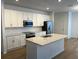 Modern kitchen with white cabinets, stainless steel appliances, and an island at 11141 Green Citron Aly, Winter Garden, FL 34787