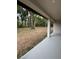 View from the back porch of a spacious backyard with mature trees providing ample shade at 116 E Cleveland St, Apopka, FL 32703