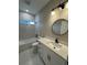 Stylish bathroom featuring modern fixtures, a marble tile shower, and a granite vanity at 116 E Cleveland St, Apopka, FL 32703