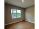 Cozy bedroom with natural light, hardwood floors, and neutral paint at 116 E Cleveland St, Apopka, FL 32703