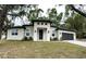 Charming single-story home with a modern design, fresh landscaping, and a two-car garage at 116 E Cleveland St, Apopka, FL 32703
