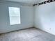 Well-lit bedroom with window and neutral-colored carpet at 12107 Bruceton Way # 102, Orlando, FL 32828