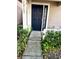 Navy blue front door with a walkway and landscaping at 12107 Bruceton Way # 102, Orlando, FL 32828