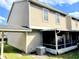 Tan two-story house with screened porch and AC unit at 12107 Bruceton Way # 102, Orlando, FL 32828