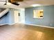 Living room with tile floors, a ceiling fan, and access to kitchen at 12107 Bruceton Way # 102, Orlando, FL 32828