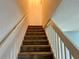 Indoor staircase with carpeted steps and neutral-colored walls at 12107 Bruceton Way # 102, Orlando, FL 32828