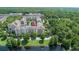 Aerial view showcasing the condo community with lake and surrounding green spaces at 1211 Stonecutter Dr # 206, Celebration, FL 34747
