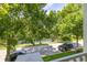 Picturesque balcony view overlooking a tranquil lake and tree-lined street at 1211 Stonecutter Dr # 206, Celebration, FL 34747