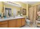 Bright bathroom featuring a large vanity, mirror, and well-lit shower at 1211 Stonecutter Dr # 206, Celebration, FL 34747