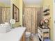 Bright bathroom featuring a large vanity, mirror, and shower at 1211 Stonecutter Dr # 206, Celebration, FL 34747
