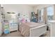 Bright bedroom with a white bed frame, bedside table, and decorated with personal touches and natural light at 1211 Stonecutter Dr # 206, Celebration, FL 34747
