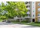 Multi-story building with balconies, landscaped grounds, and street parking at 1211 Stonecutter Dr # 206, Celebration, FL 34747