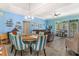 Dining area features a round table with vibrant, striped chairs and an open view to the living room, creating an inviting space at 1211 Stonecutter Dr # 206, Celebration, FL 34747