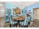 Dining area featuring a round table with blue striped chairs, showcasing the kitchen with bright white appliances at 1211 Stonecutter Dr # 206, Celebration, FL 34747
