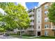 Condominium building featuring private balconies, lush landscaping, and convenient covered parking at 1211 Stonecutter Dr # 206, Celebration, FL 34747