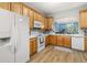 Kitchen featuring wooden cabinets, white countertops, and appliances with an open view to the living room at 1211 Stonecutter Dr # 206, Celebration, FL 34747