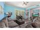 Living room with light blue walls, a comfortable sectional, and a large window offers tranquil natural lighting at 1211 Stonecutter Dr # 206, Celebration, FL 34747
