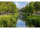 Landscaped community waterway with lush greenery, trees, and a bridge at 1211 Stonecutter Dr # 206, Celebration, FL 34747