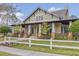 Craftsman style home with a front porch and landscaped yard at 1211 Stonecutter Dr # 206, Celebration, FL 34747