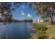 Scenic lakefront property with a view of a charming building and lush landscaping at 1211 Stonecutter Dr # 206, Celebration, FL 34747