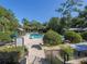 Community pool with lounge chairs and shaded areas at 1211 Stonecutter Dr # 206, Celebration, FL 34747