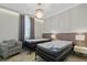 Charming bedroom with twin beds, a comfortable chair and a chandelier at 12754 Brodlove Ln, Winter Garden, FL 34787