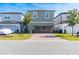 Two-story home with gray siding, a paved driveway, and landscaping at 12754 Brodlove Ln, Winter Garden, FL 34787