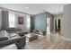 Spacious Gathering room featuring a large sectional sofa and light wood floors at 12754 Brodlove Ln, Winter Garden, FL 34787
