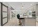 Modern kitchen island with green velvet barstools and gray countertops at 12754 Brodlove Ln, Winter Garden, FL 34787
