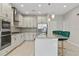 Modern kitchen with white cabinets, gray countertops, and stainless steel appliances at 12754 Brodlove Ln, Winter Garden, FL 34787