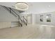 Bright and airy living room with stylish chandelier and staircase at 12754 Brodlove Ln, Winter Garden, FL 34787