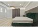 Elegant main bedroom with large bed, gray walls and chandelier at 12754 Brodlove Ln, Winter Garden, FL 34787