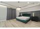 Luxurious main bedroom with plush green velvet headboard and chandelier at 12754 Brodlove Ln, Winter Garden, FL 34787