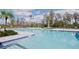 Community pool with lounge chairs and lush landscaping at 12754 Brodlove Ln, Winter Garden, FL 34787