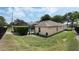 Backyard showing a screened-in pool, lush greenery and fencing for privacy at 14101 Vista Del Lago Blvd, Clermont, FL 34711