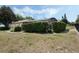Backyard features lush greenery, a screened pool, and a fence for privacy at 14101 Vista Del Lago Blvd, Clermont, FL 34711